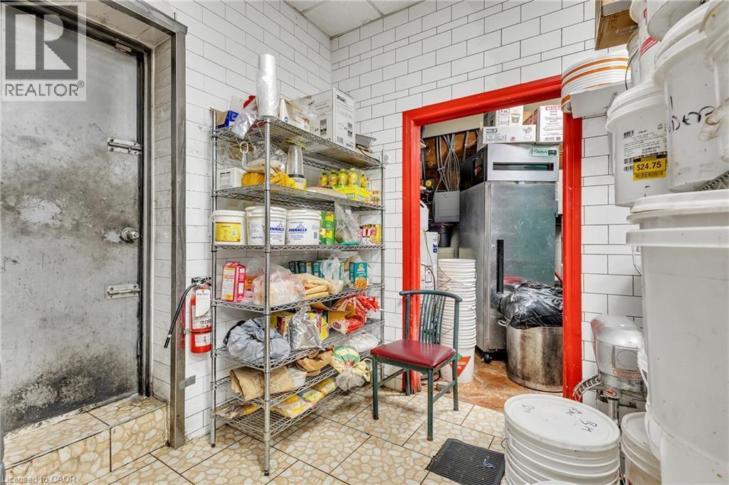 Commercial-grade space featuring white subway tile walls and textured floor tiles - 155 Highland Road E, Kitchener, ON