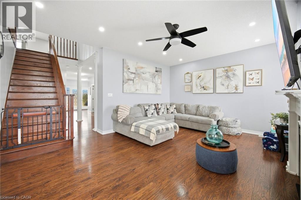 Living area featuring wood-finish flooring, recessed lighting, and a modern ceiling fan - 79 Garinger Crescent, Hamilton, ON