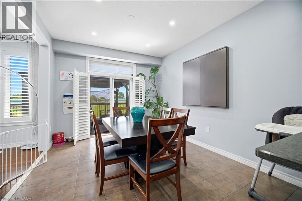 Dining area featuring a sliding glass door with louvered shutters, recessed lighting, and tile flooring - 79 Garinger Crescent, Hamilton, ON
