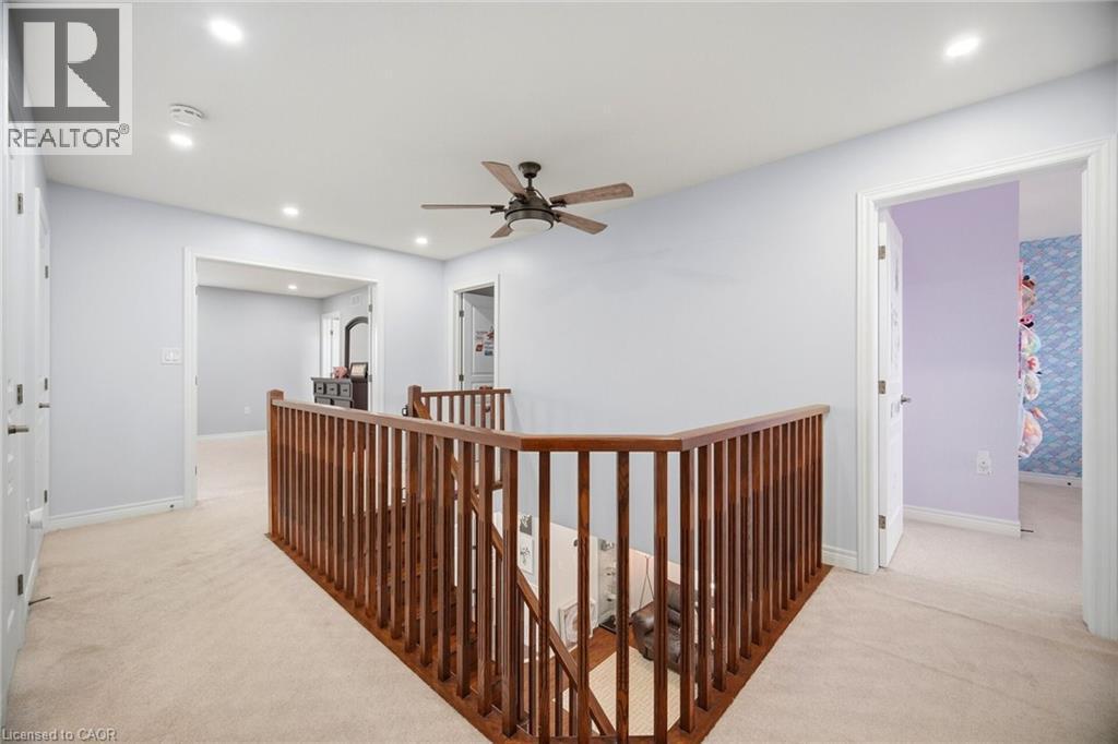 Upper-level landing featuring wood balusters, recessed lighting, and a ceiling fan - 79 Garinger Crescent, Hamilton, ON