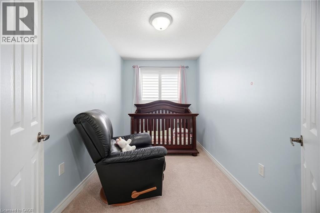 Room featuring soft blue wall paint, white trim, and light beige carpet flooring - 79 Garinger Crescent, Hamilton, ON