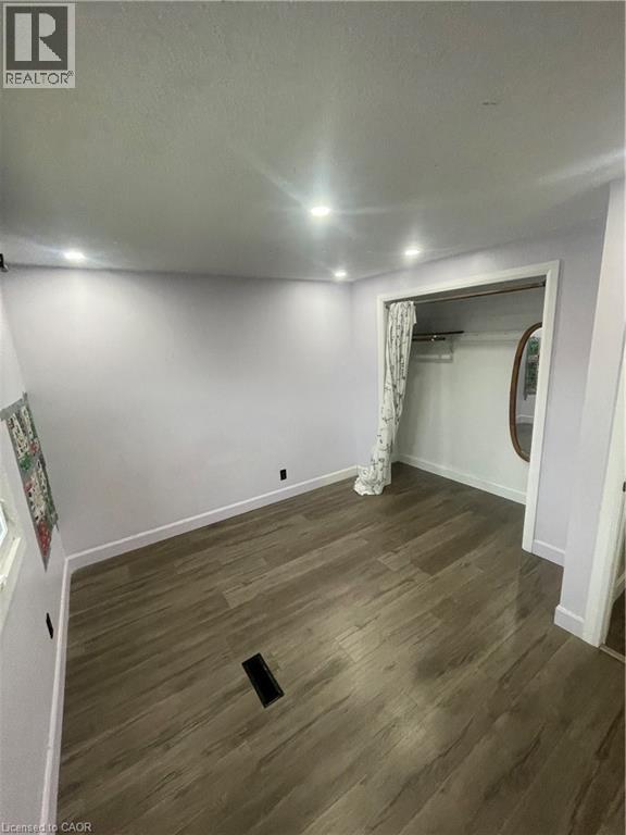 Interior room featuring wood-finish flooring, recessed ceiling lighting, and a closet with a curtained entry - 134 Bridgeport Road E Unit# Upper, Waterloo, ON