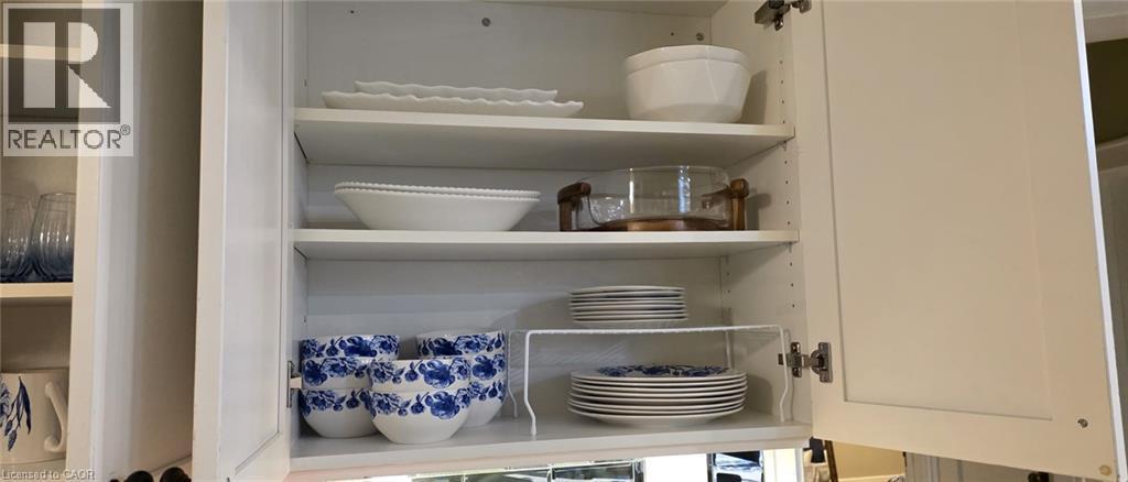 White shaker-style upper cabinetry featuring adjustable shelving - 134 Bridgeport Road E Unit# Upper, Waterloo, ON
