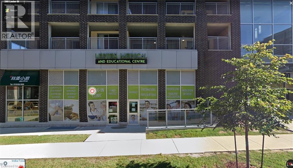 Commercial storefront featuring multiple large windows, a central entrance, and an overhead sign - 280 Lester Street Unit# 607, Waterloo, ON