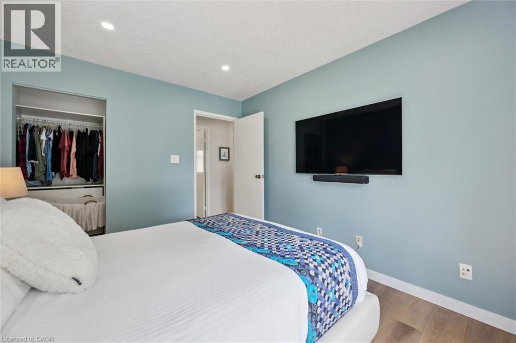 Interior room featuring light blue walls and wood-finish flooring - 2 Keewatin Avenue, Kitchener, ON