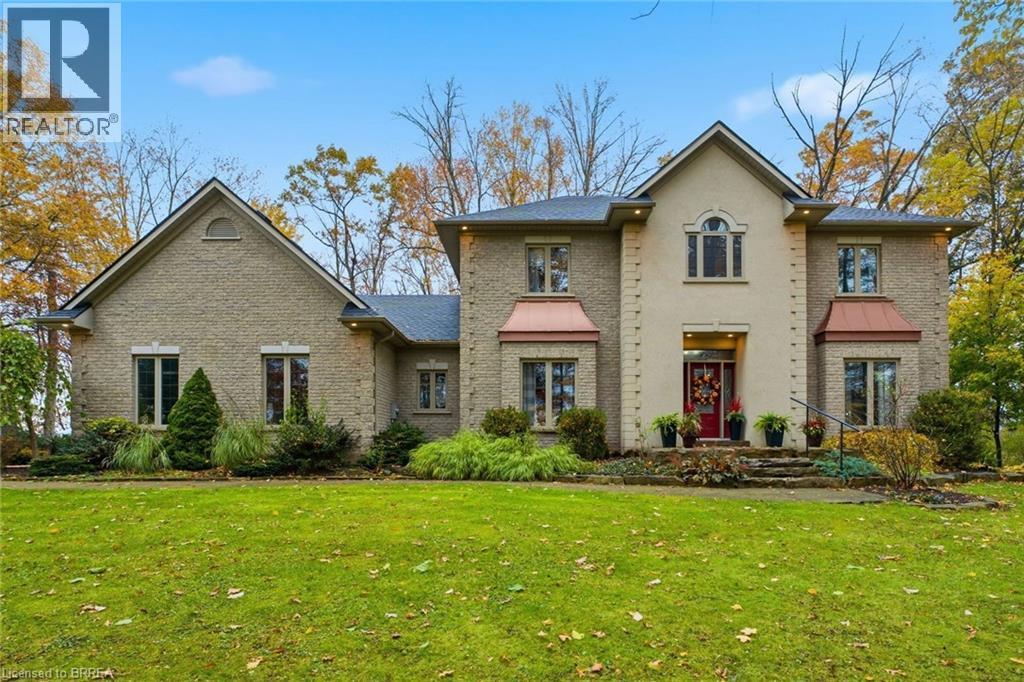 Stone facade residence featuring a prominent red entry door - 271 Windham Rd 14, Simcoe, ON