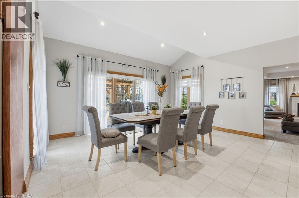 Dining area featuring light-toned tile flooring, a vaulted ceiling, and recessed lighting - 271 Windham Rd 14, Simcoe, ON