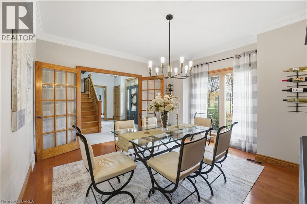 Dining area featuring wood-finish flooring and crown molding - 271 Windham Rd 14, Simcoe, ON