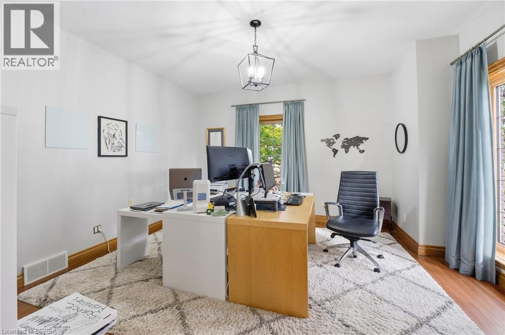 Room featuring wood-finish flooring, a textured area rug, and a central ceiling light fixture - 271 Windham Rd 14, Simcoe, ON