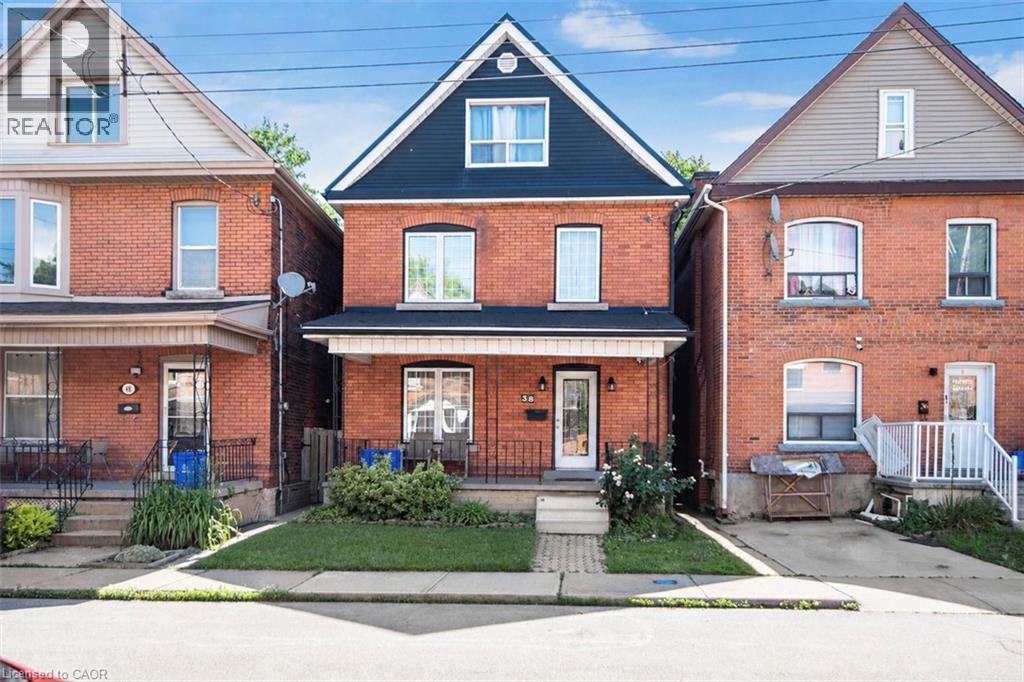 Brick exterior featuring a gabled roofline with dark siding - 38 Fairleigh Avenue N, Hamilton, ON