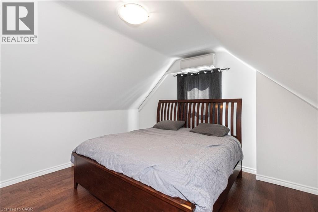 Attic space with sloped ceilings and rich wood-finish flooring - 38 Fairleigh Avenue N, Hamilton, ON
