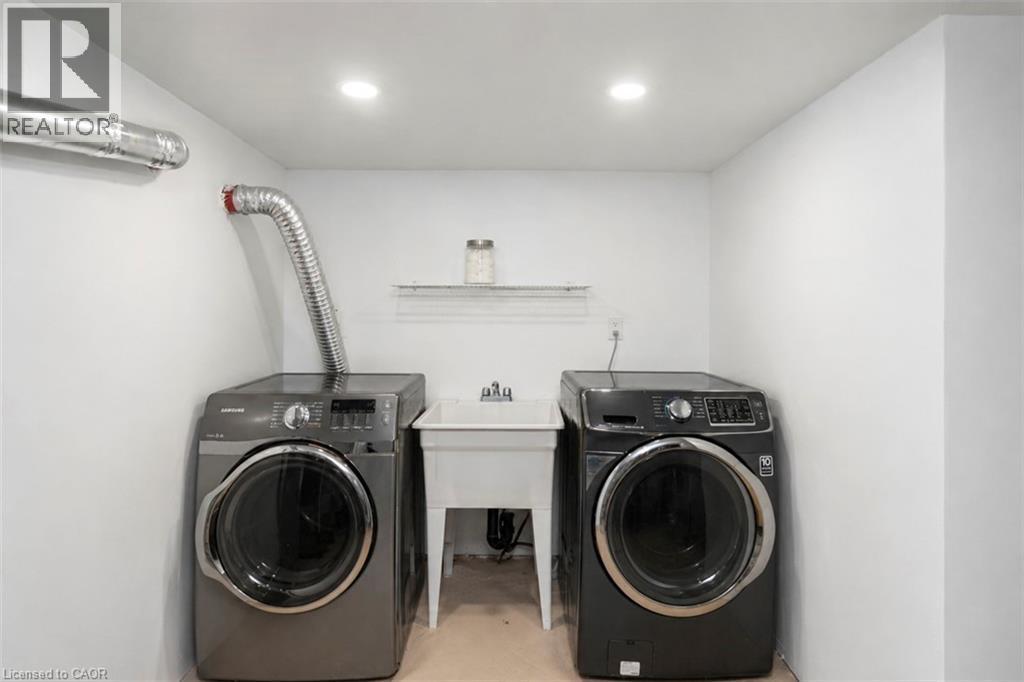 Dedicated laundry area featuring a utility sink, recessed lighting, and wall-mounted shelving - 38 Fairleigh Avenue N, Hamilton, ON