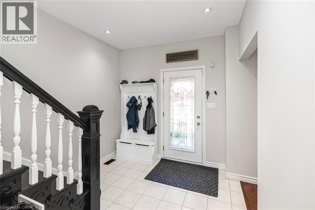 Foyer featuring a decorative glass-paneled entry door, recessed lighting, and ceramic tile flooring - 38 Fairleigh Avenue N, Hamilton, ON