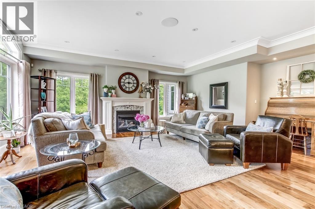 Living room with gas fireplace, pot lights and large windows to enjoy the view of the large, private yard. - 59 Decou Road, Simcoe, ON
