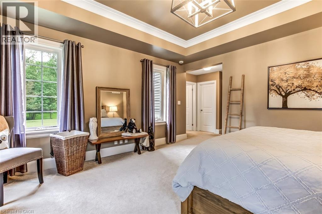 Primary Bedroom is on the main floor, features modern lighting, large windows and private entry. - 59 Decou Road, Simcoe, ON