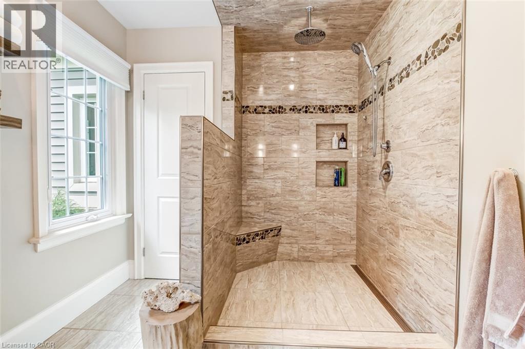Primary ensuite features a large walk in, tiled shower and linen closet - 59 Decou Road, Simcoe, ON