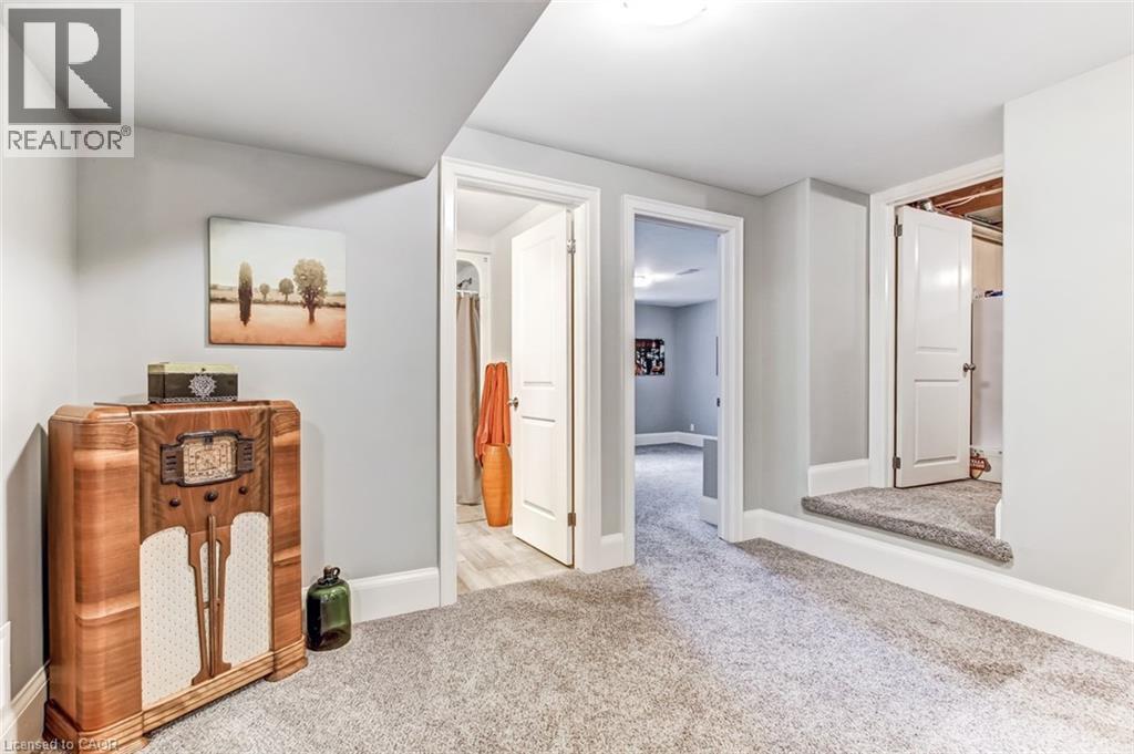 Part of the rec-room showing access to bath and bedrooms. - 59 Decou Road, Simcoe, ON