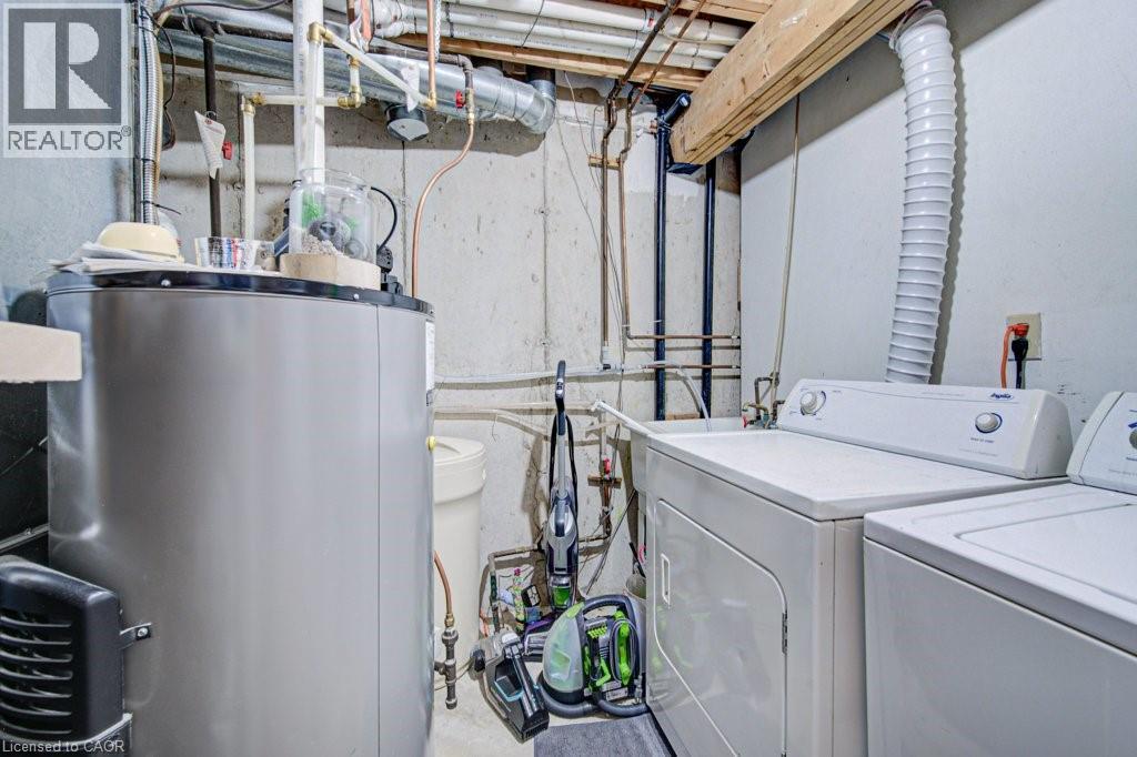Dedicated utility area featuring a water heater, washer, and dryer - 854 Elgin Street N, Cambridge, ON