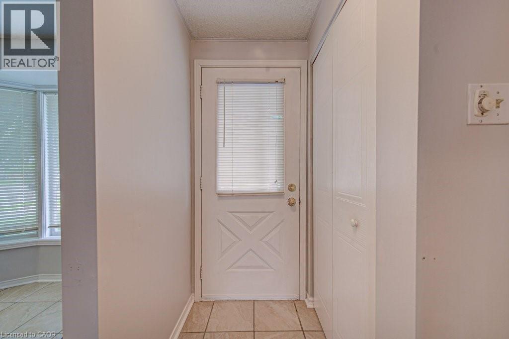 Entryway featuring a white door with X-panel detailing and an integrated window blind - 854 Elgin Street N, Cambridge, ON
