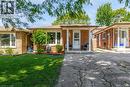 Brick exterior residence with a covered front porch and a white entry door - 338 East 24Th Street, Hamilton, ON 