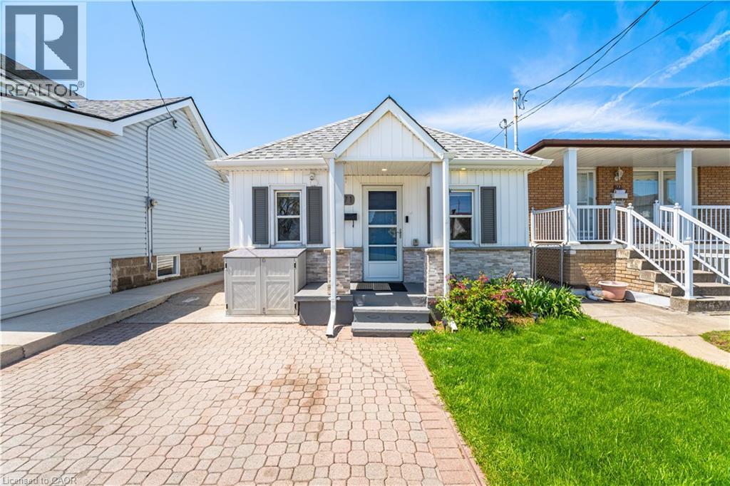 Charming bungalow with white siding and a stone facade - 71 Beland Avenue N, Hamilton, ON - Outdoor With Deck Patio Veranda With Facade