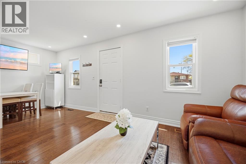 Bright interior space featuring wood-finish flooring, recessed lighting, and white walls - 71 Beland Avenue N, Hamilton, ON - Indoor Photo Showing Living Room