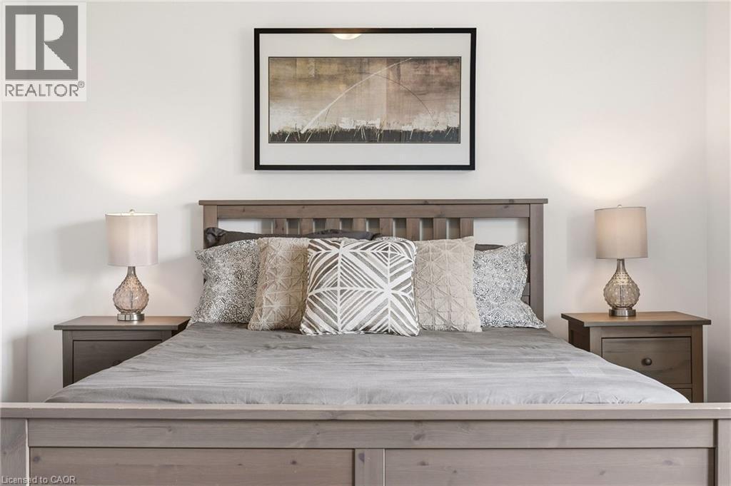 Bedroom featuring a wood-finish bed frame and matching nightstands - 4171 Palermo Common, Burlington, ON - Indoor Photo Showing Bedroom