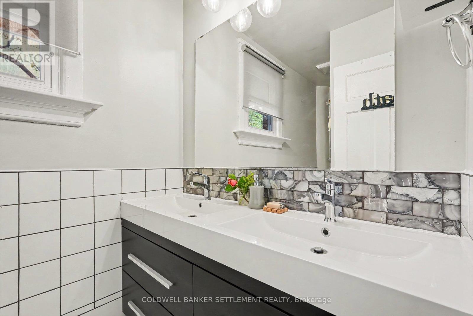 Renovated main bathroom with double vanity. - 1 Burchell Boulevard, Perth, ON - Indoor Photo Showing Bathroom