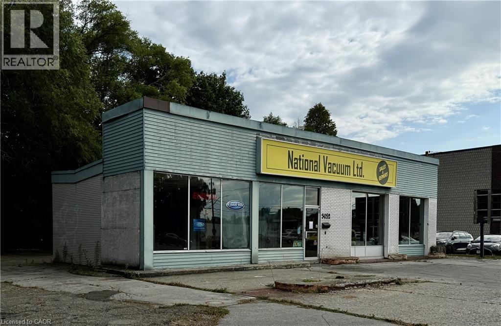 Commercial storefront building featuring a prominent yellow signage panel - 3052 New Street, Burlington, ON