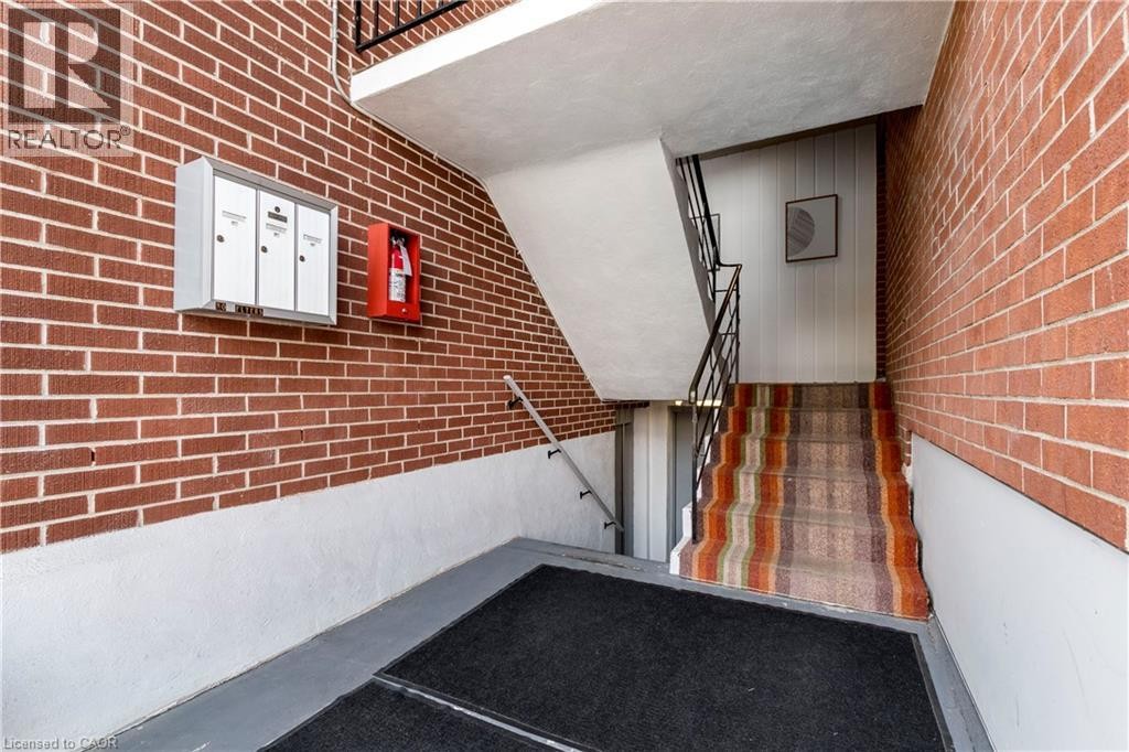 Brick wall exterior with white painted lower half - 43 Sixth Avenue, Kitchener, ON - Indoor Photo Showing Other Room