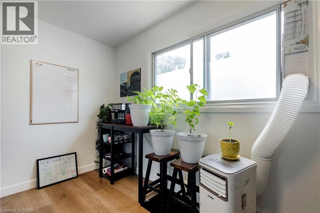 Interior room with wood-finish flooring and white baseboards - 43 Sixth Avenue, Kitchener, ON - Indoor Photo Showing Other Room