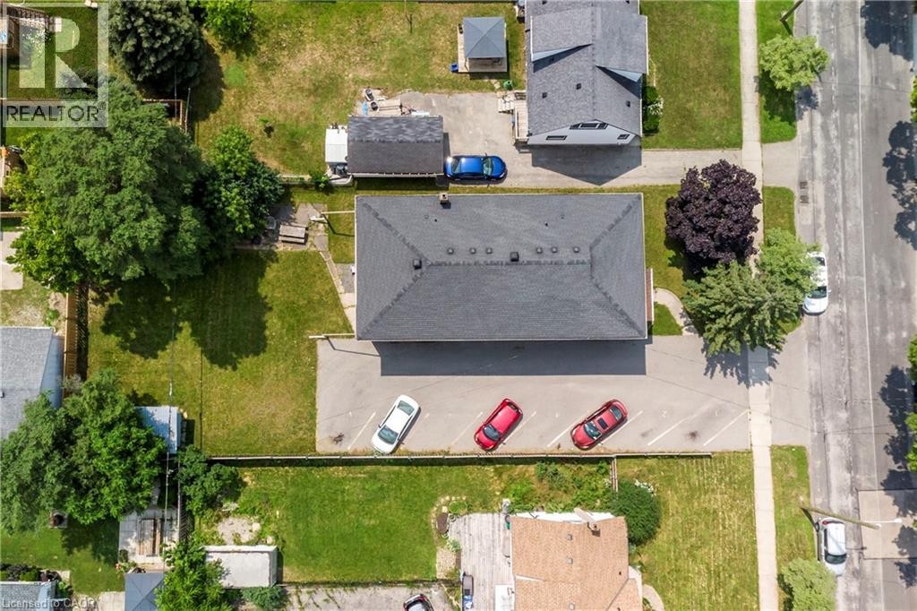 Central building with a dark shingle roof, surrounded by paved parking areas - 43 Sixth Avenue, Kitchener, ON - Outdoor With View