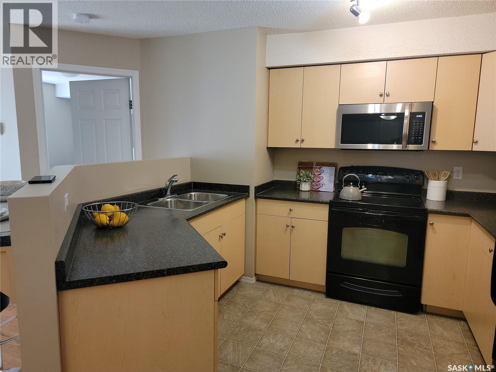 204 303 Lowe Road, Saskatoon, SK - Indoor Photo Showing Kitchen With Double Sink
