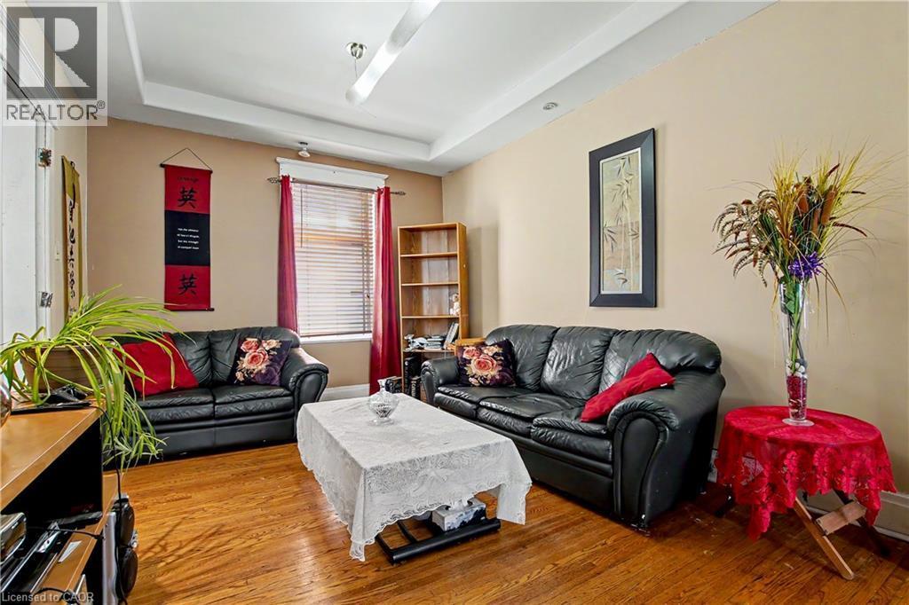 2nd Floor Living area featuring wood-finish flooring, neutral wall paint, and a tray ceiling - 30 Hohner Avenue, Kitchener, ON - Indoor Photo Showing Living Room