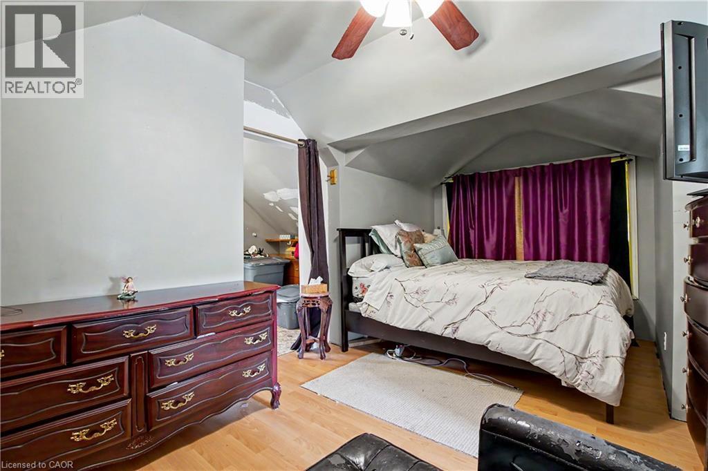 3rd Floor bedroom featuring wood-finish flooring, a ceiling fan with integrated lighting - 30 Hohner Avenue, Kitchener, ON - Indoor Photo Showing Bedroom