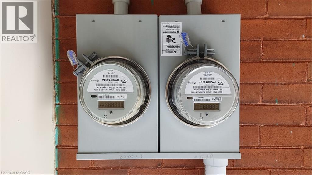 Dual utility meters mounted on a brick exterior wall - 30 Hohner Avenue, Kitchener, ON -