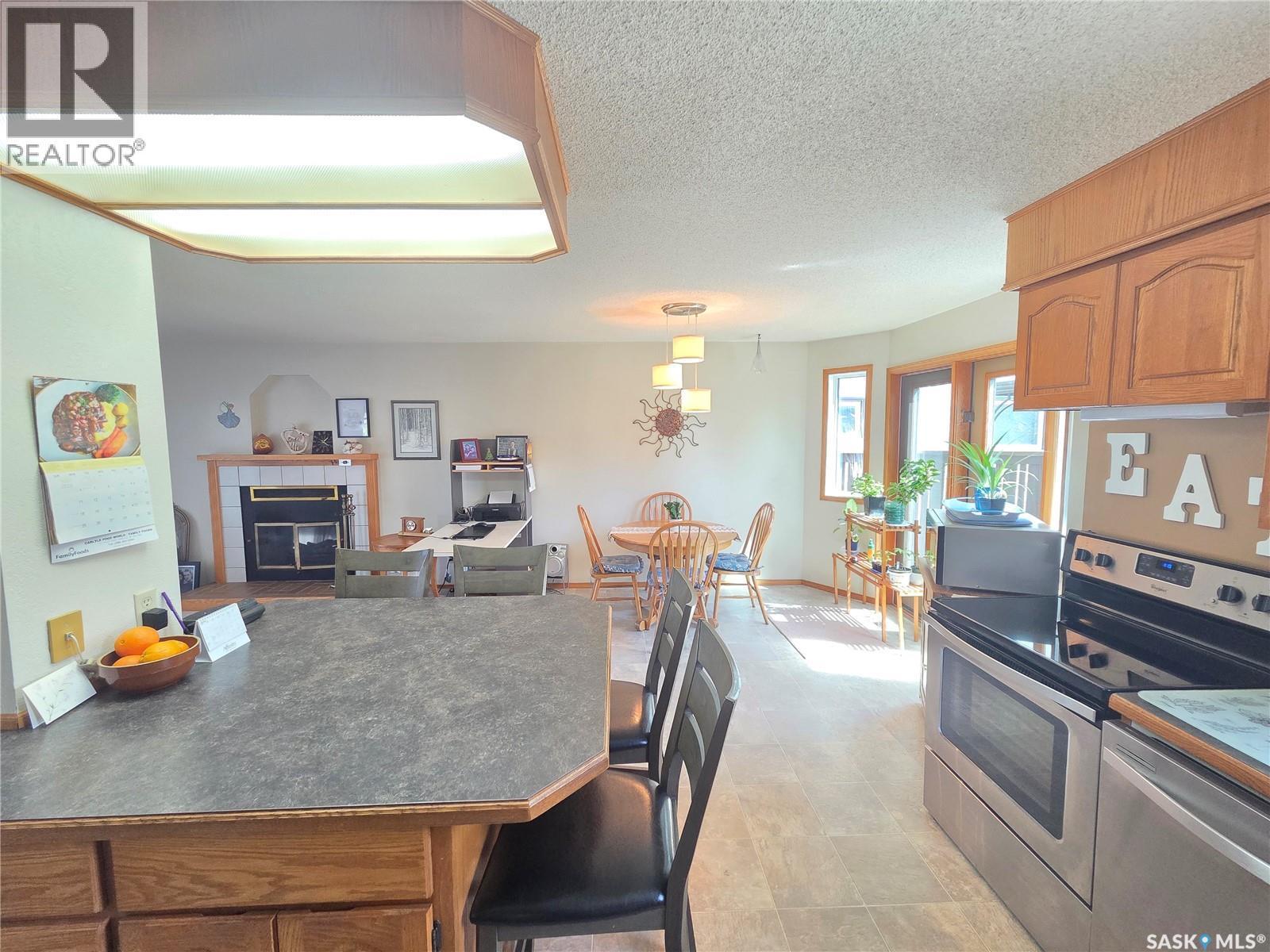 509 Carlyle Avenue, Carlyle, SK - Indoor Photo Showing Kitchen With Fireplace