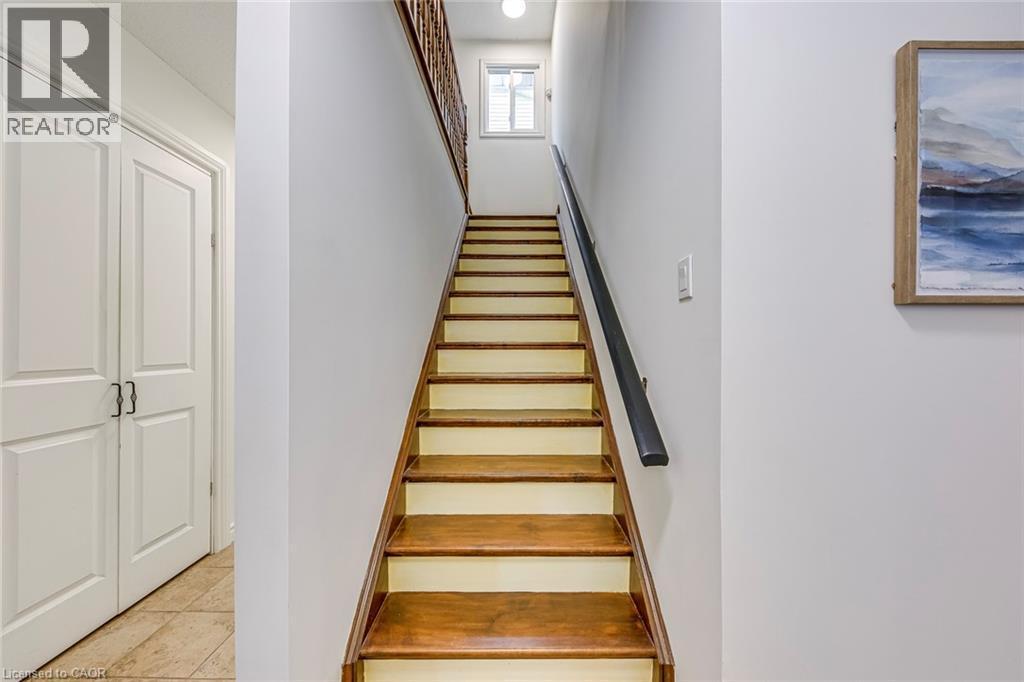 Staircase with wood-finish treads and white risers - 43 Niska Drive, Waterdown, ON - Indoor Photo Showing Other Room