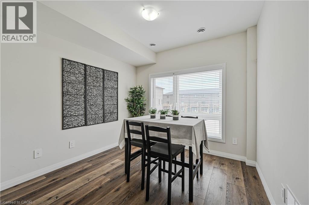 Dining area featuring wood-finish flooring, a large window with blinds, and recessed lighting - 720 Grey Street Unit# 34, Brantford, ON - Indoor Photo Showing Dining Room