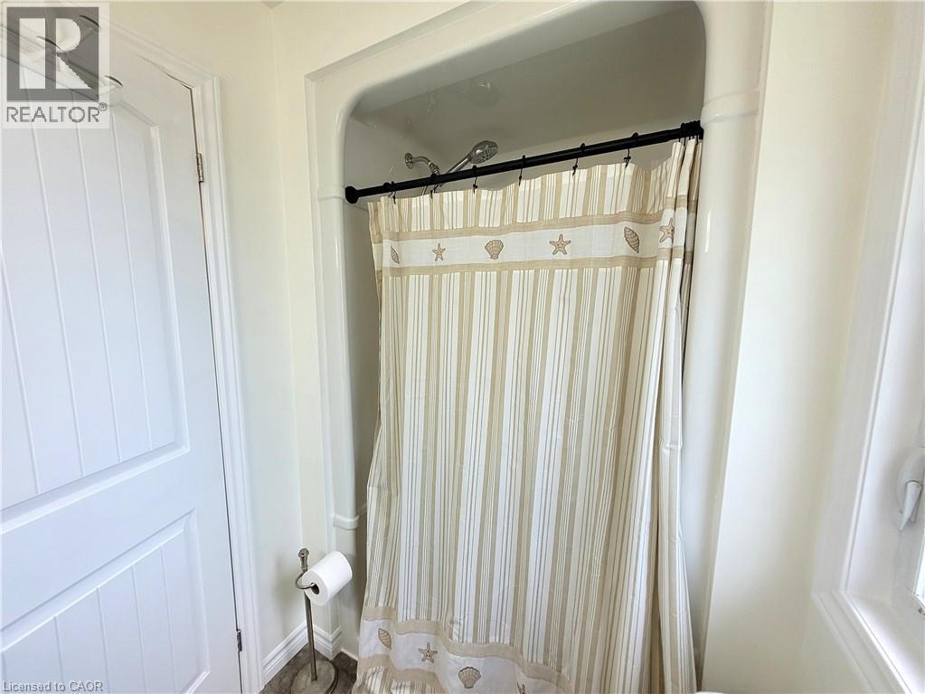Shower enclosure with a ceiling-mounted showerhead and white wall finishes - 296 Donly Drive S, Simcoe, ON