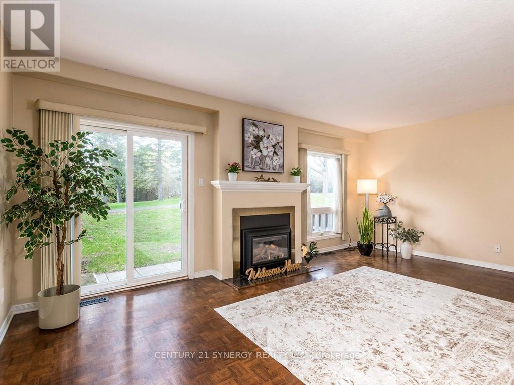 Living room with patio doors to back yard. - 80 - 22C Maple Ridge Crescent, Ottawa, ON - Indoor Photo Showing Living Room With Fireplace