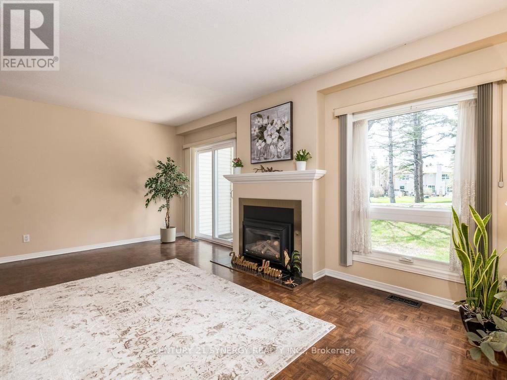 Living room with patio doors to back yard. - 80 - 22C Maple Ridge Crescent, Ottawa, ON - Indoor Photo Showing Living Room With Fireplace