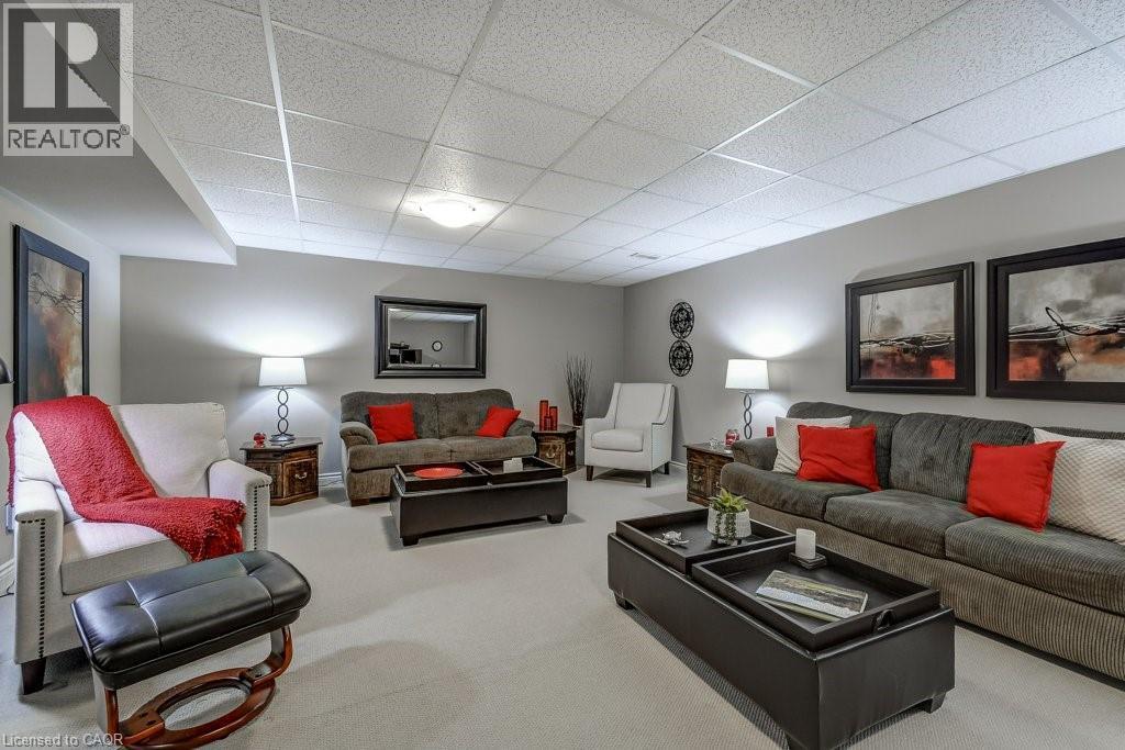 Spacious room featuring light gray walls, light-toned carpeting, and a drop ceiling with recessed lighting - 605 Welland Avenue Unit# 21, St. Catharines, ON - Indoor Photo Showing Living Room