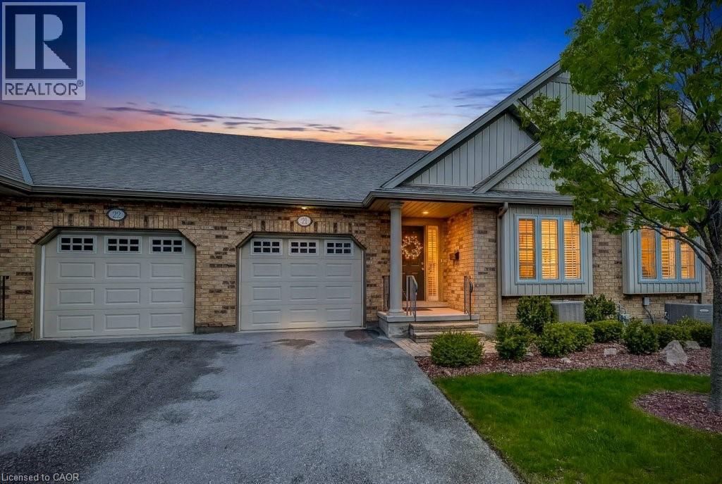 Brick exterior with a shingle roof and a two-car garage - 605 Welland Avenue Unit# 21, St. Catharines, ON - Outdoor With Facade