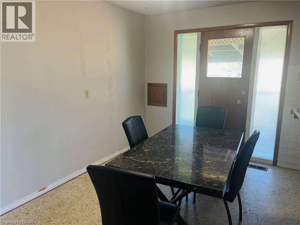 Entryway featuring a wood-panel door with a glass insert, flanked by two vertical frosted glass sidelights - 157 Schweitzer Street, Kitchener, ON - Indoor Photo Showing Dining Room