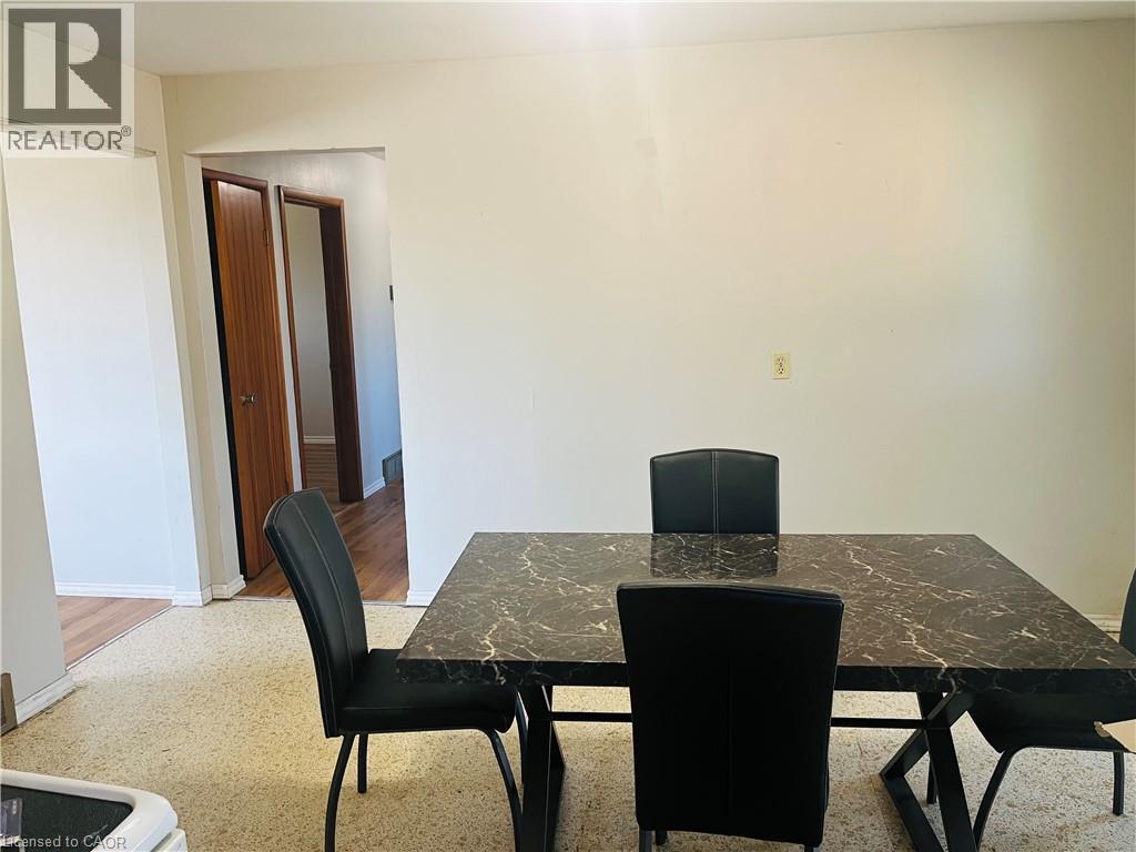 Dining area featuring light-toned flooring, a light-colored wall, and a wide doorway - 157 Schweitzer Street, Kitchener, ON - Indoor Photo Showing Dining Room
