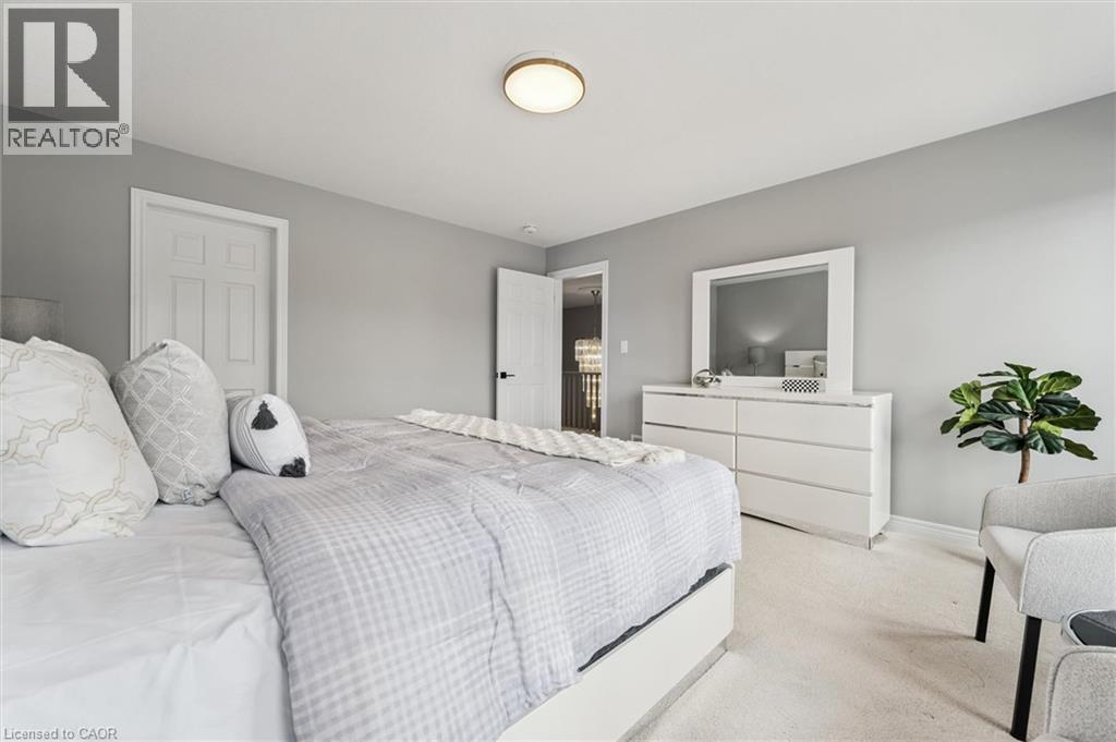 Light gray wall paint complemented by white trim and a neutral carpet - 628 Florencedale Crescent, Kitchener, ON