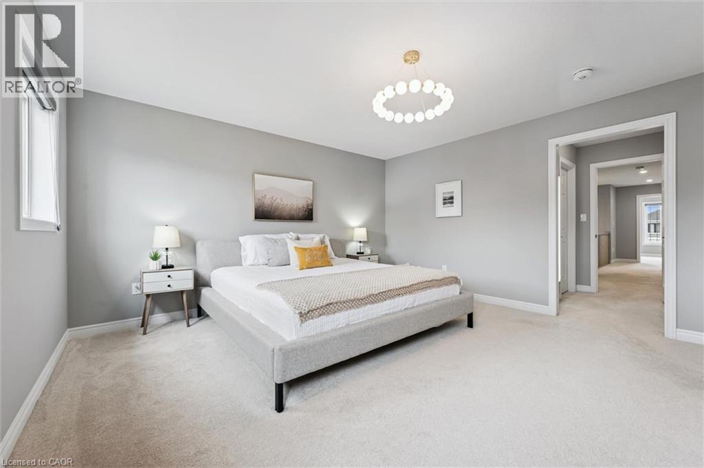 Bedroom featuring light gray walls, plush carpet flooring, and a modern circular ceiling light fixture - 628 Florencedale Crescent, Kitchener, ON