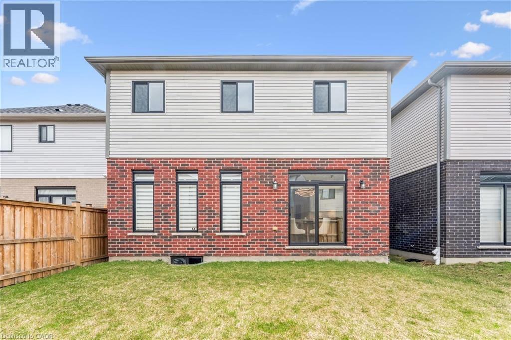 Rear elevation featuring red brick and light siding - 628 Florencedale Crescent, Kitchener, ON