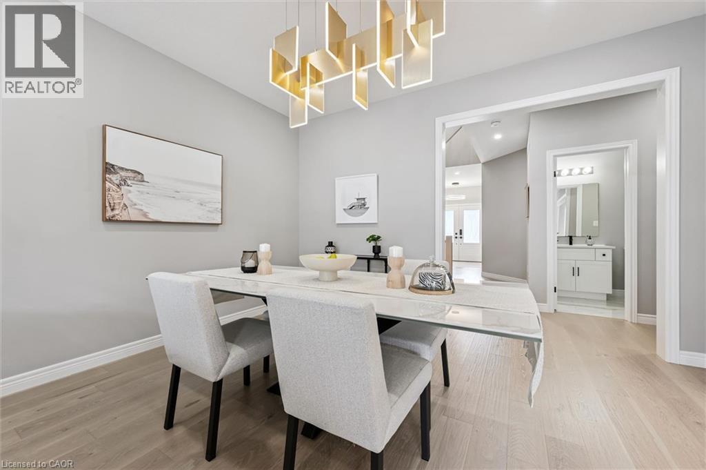 Dining area featuring a modern geometric chandelier and light wood-finish flooring - 628 Florencedale Crescent, Kitchener, ON